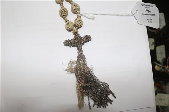 A reticulated ivory bead and tassel drop rosary necklace, 100cm.